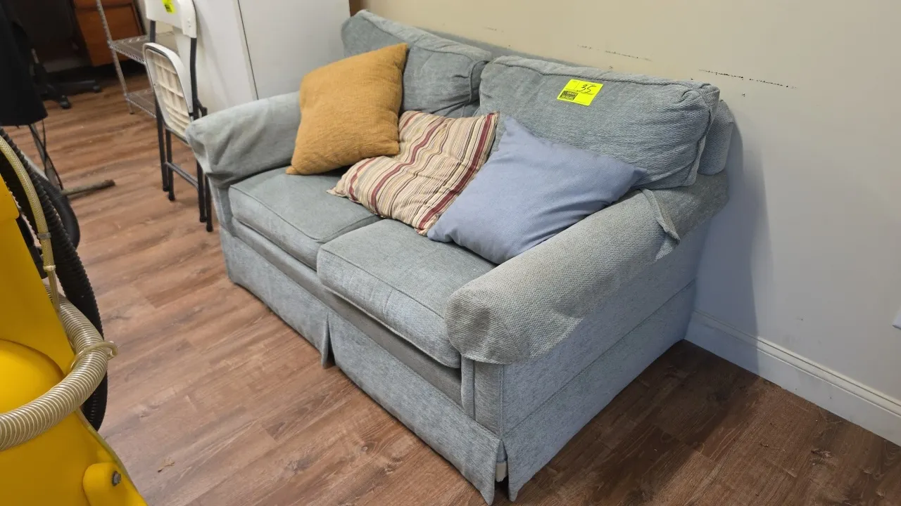 Upholstered loveseat. Features rolled arms, skirted base, and dual seat cushions. Includes (3) accent pillows. Dimensions: 5' x 3' x 3'.