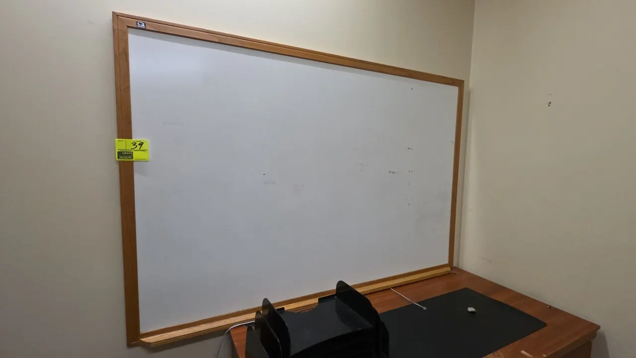 Quartet dry erase board. Features a wood finish frame with integrated marker tray. Dimensions: 6' x 4'. Desk and accessories not included.