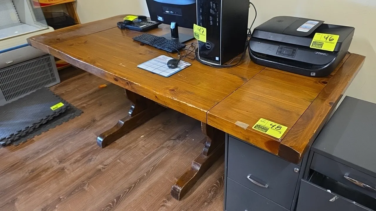 Solid wood table. Features a plank-style top and trestle base with center stretcher. Dimensions: 7' x 3' x 2'8". Contents not included.