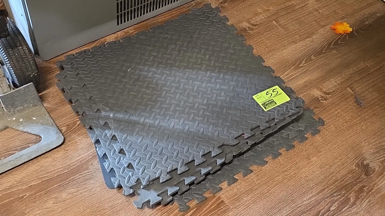 Foam interlocking floor mats. Features dark gray foam construction with diamond plate textured surfaces and interlocking puzzle edges. Dimensions: 24"