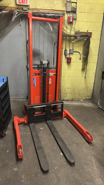 2021 Ballymore BallyPal 22AG-63 electric straddle stacker. Features a 2,200 lb capacity, 63" maximum lift height, single-stage mast with wire safety g