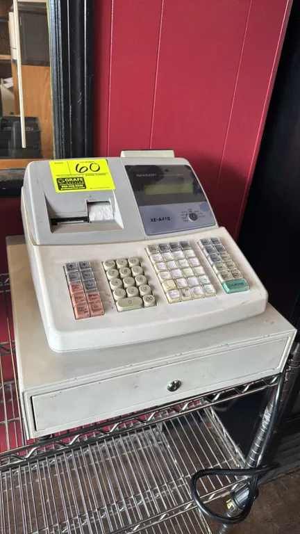 Sharp XE-A41S electronic cash register. Features raised-key keypad, operator display, built-in thermal receipt printer, and integrated locking cash dr