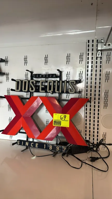 Dos Equis illuminated neon advertising sign. Features glass neon lettering reading 'Dos Equis', dimensional backlit red 'XX' center logo, and 'Cerveza
