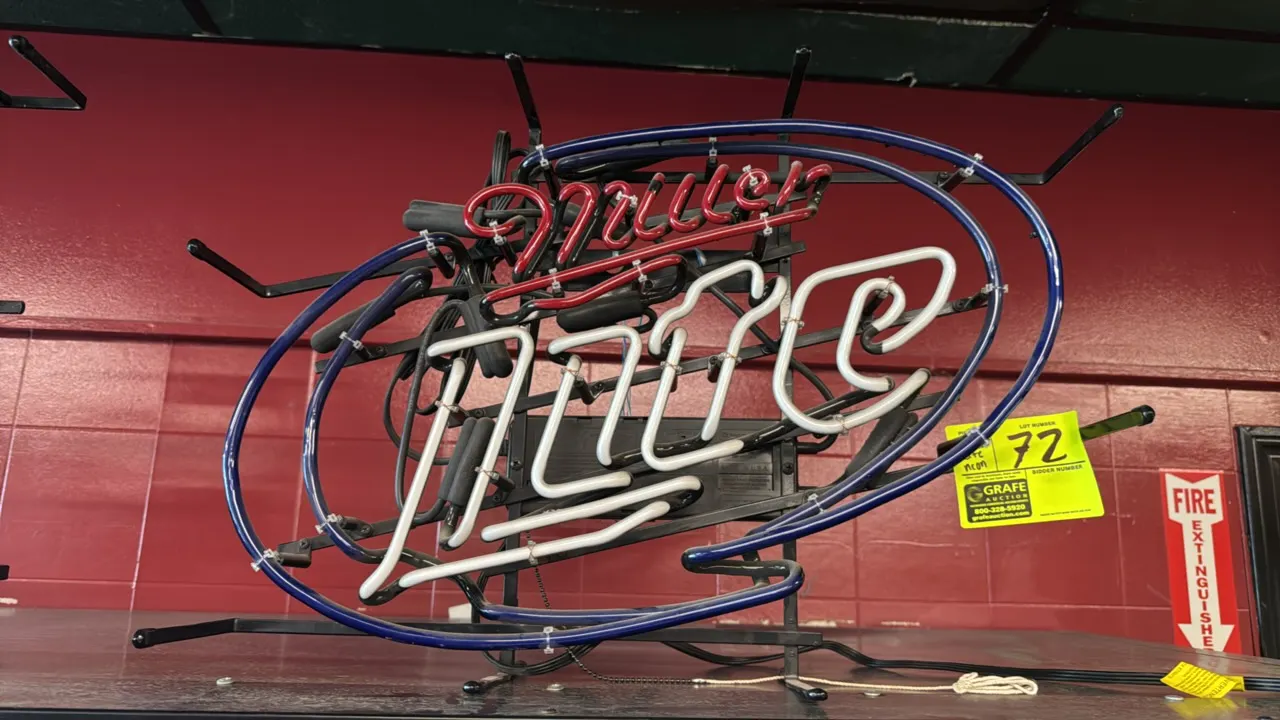 Miller Lite neon sign. Features red, white, and blue neon tubing mounted on a black metal skeleton frame with integrated power supply and pull-chain s