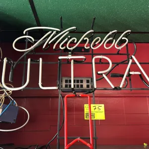 Michelob Ultra neon sign. Features red and white neon glass tubing mounted to a black metal wire frame with integrated power supply and cord. 32" x 28