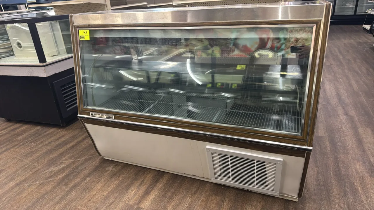 Master-Bilt slant glass meat and seafood service display case. Features self-contained refrigeration, upper gravity coil, rear sliding glass service d