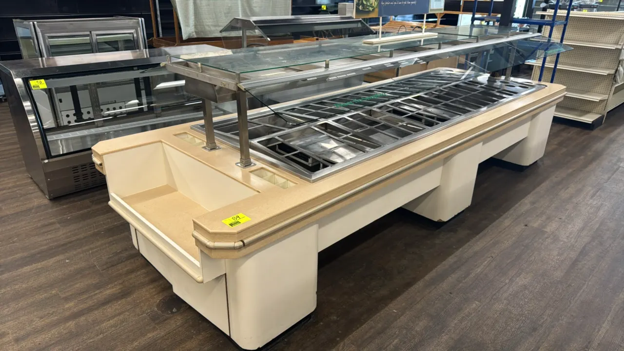 2003 Amtekco custom refrigerated salad bar. Features glass sneeze guards, stainless steel refrigerated well with pan divider racks, overhead lighting,