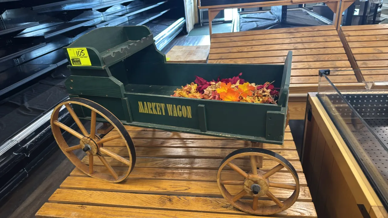 D.E. Vine Market Wagon decorative wood display wagon. Features a dark green painted finish with stenciled lettering, elevated driver seat bench, and w