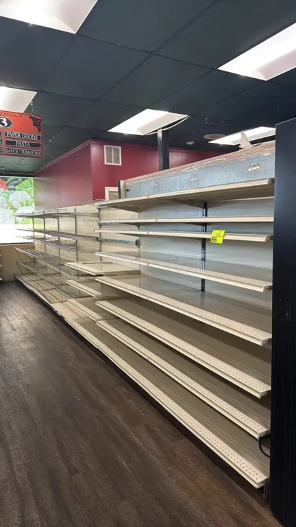 28'L of Lozier wall shelving. 72"H uprights with 22"D base shelves. Features adjustable solid metal shelving, wire display shelves, and hanging hooks.