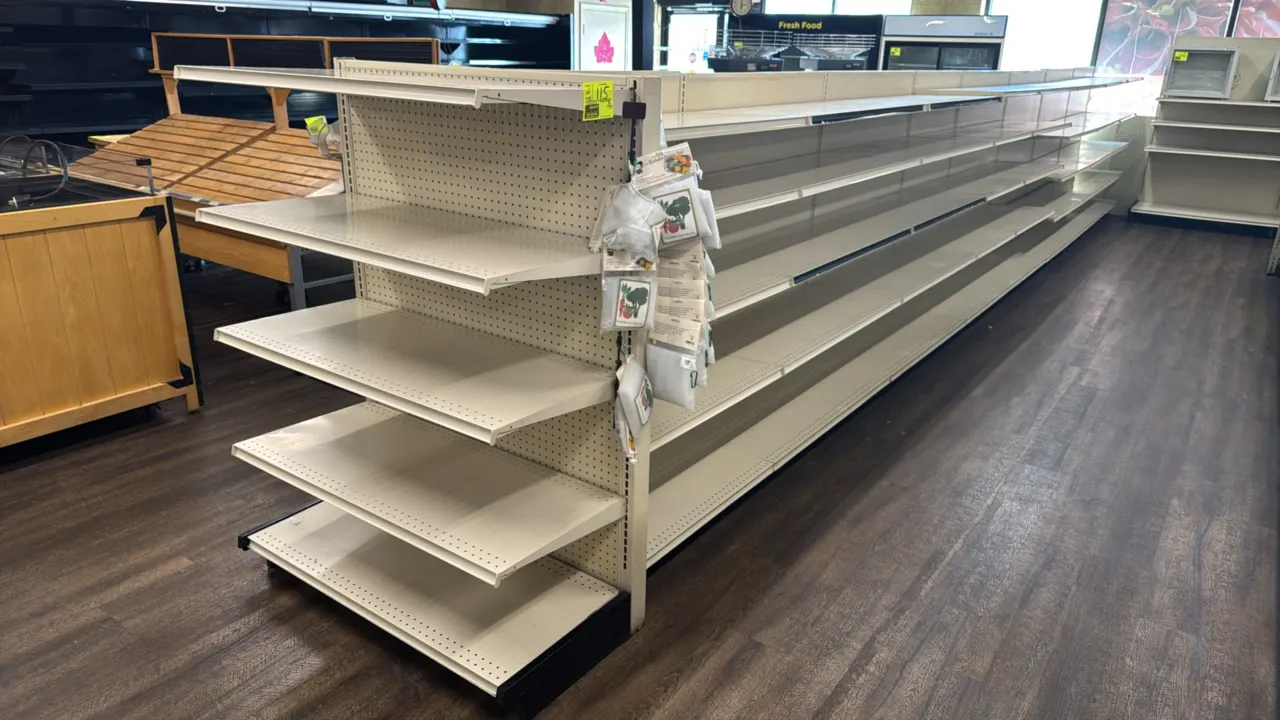 66'L of Lozier gondola store shelving. 60"H uprights with 19"D base shelves. Features pegboard backing and adjustable metal upper shelves. Contents no