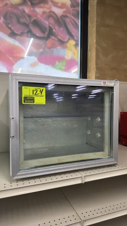 Caravell countertop mini display freezer. Features a hinged glass display door, aluminum frame, and textured aluminum interior with shelf supports. 22