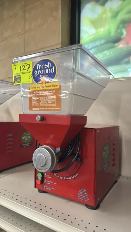 2016 Olde Tyme PN2 nut grinder. Features a clear plastic hopper with lid and push-button operation controls. S/N: A16081027. Electrical: 115V, 60 Hz,