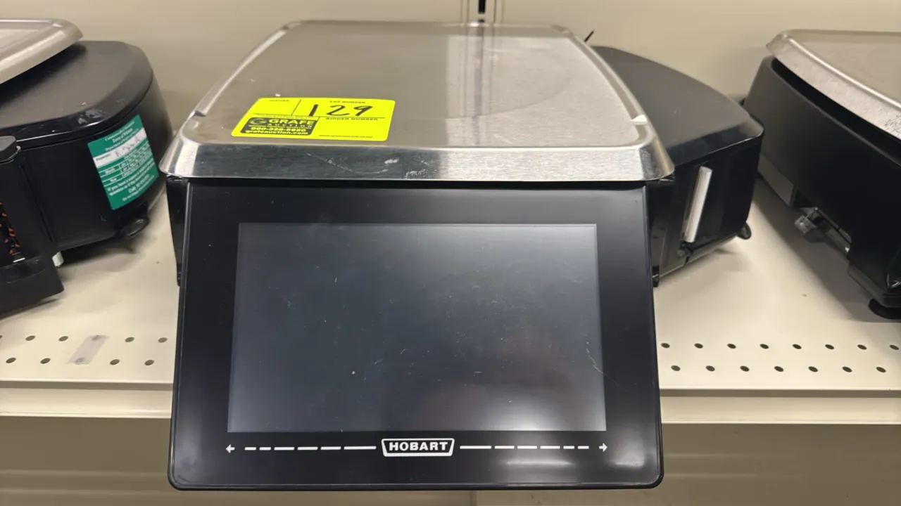 Hobart HTi touchscreen electronic scale with integrated label printer. Features a stainless steel weigh platter and color touchscreen display. 30 lb c