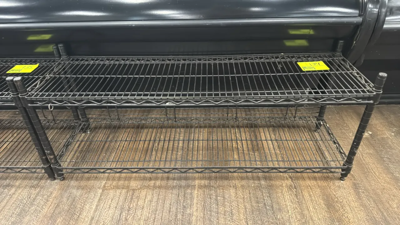 Coated metal 2-tier wire shelving rack. Features 2 wire shelves with a rear/side retaining rail on the bottom shelf. Dimensions: 48"L x 14"W x 19"H. M