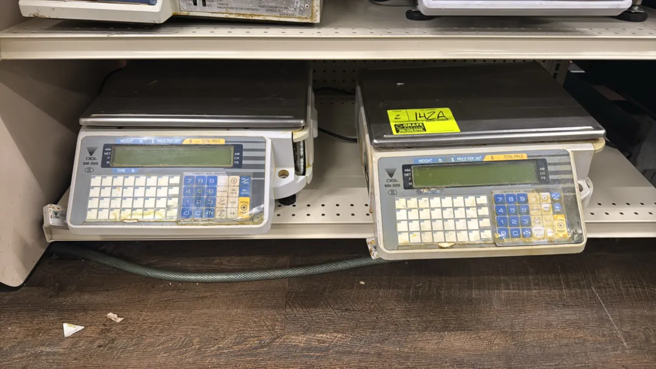 Digi SM-300 electronic computing scales with integrated label printers. Features 30 lb x 0.01 lb capacity, stainless steel weighing platters, membrane