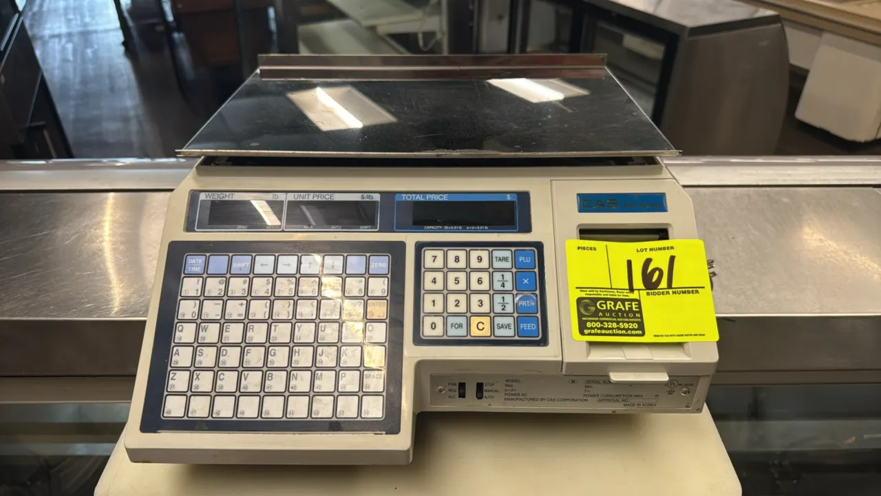 CAS LP-1000 electronic scale with label printer. Features 30 lb capacity, stainless steel weighing platter, digital display, and preset keypad. S/N: P