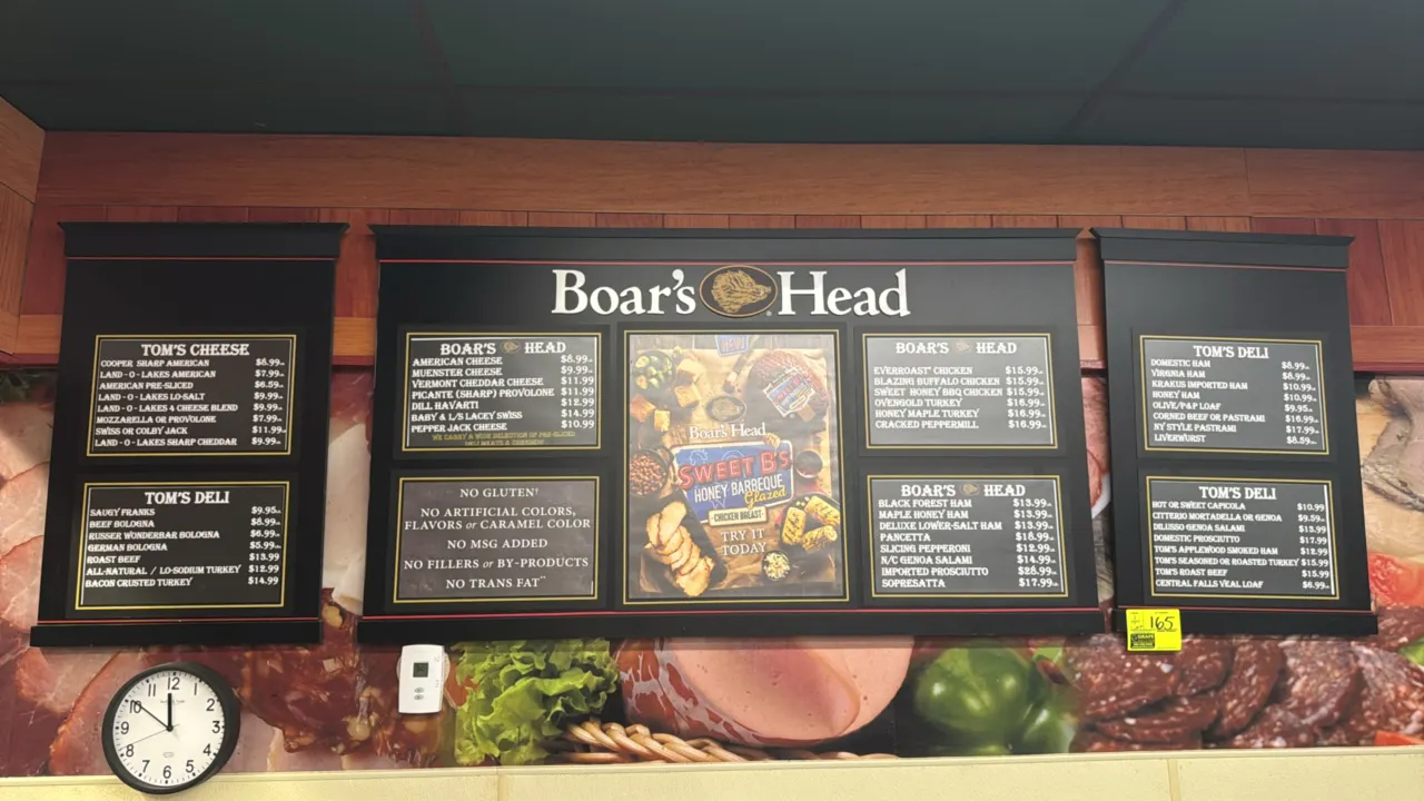 Boar's Head deli menu boards with wall clock. Includes (1) center Boar's Head branded board with menu insert slots and promotional display insert, (2)