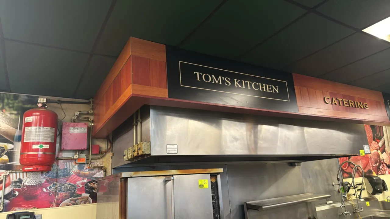Stainless steel exhaust hood with Amerex KP600 fire suppression system and (2) exhaust fans. Features stainless steel baffle grease filters, suppressi