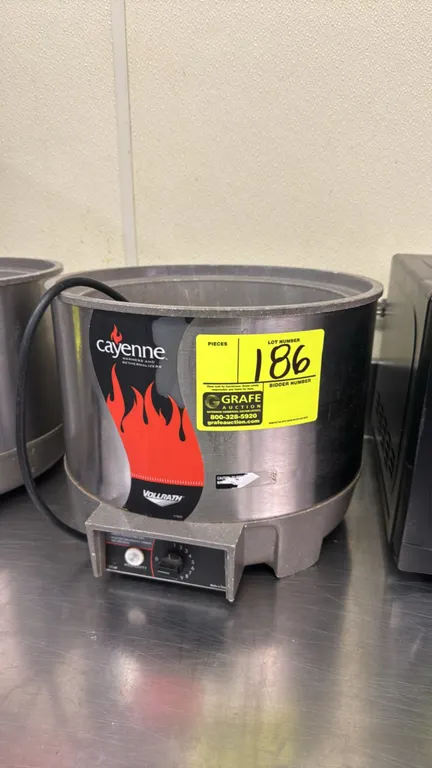 Vollrath Cayenne round soup warmer. Features stainless steel exterior, analog rotary temperature control dial (1-10), and 'well empty' indicator light