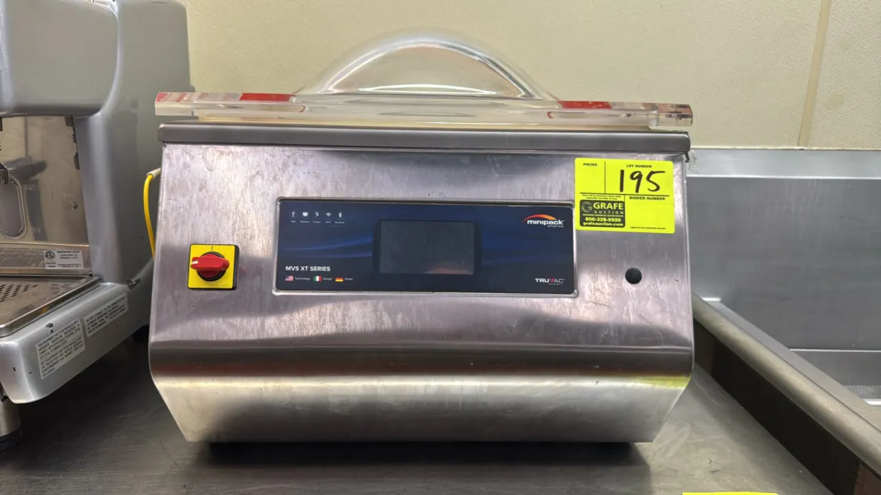 2016 Minipack MT45IE38 chamber vacuum sealer. Stainless steel construction. Features dual seal bars, clear domed lid, digital control interface, and c