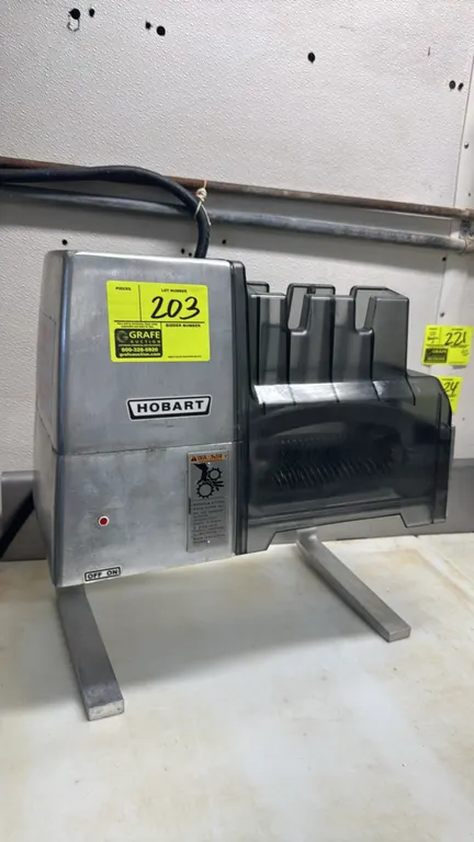 Hobart 403 electric meat tenderizer. Features cast aluminum housing, dual tenderizer blade rollers, and removable transparent safety cover. S/N: 31152