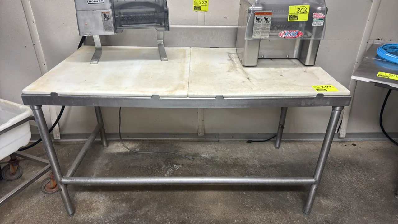 Stainless steel poly top work table. Features a two-piece poly cutting board top, rear backsplash, and tubular legs with cross-bracing. 60"x30". Mount