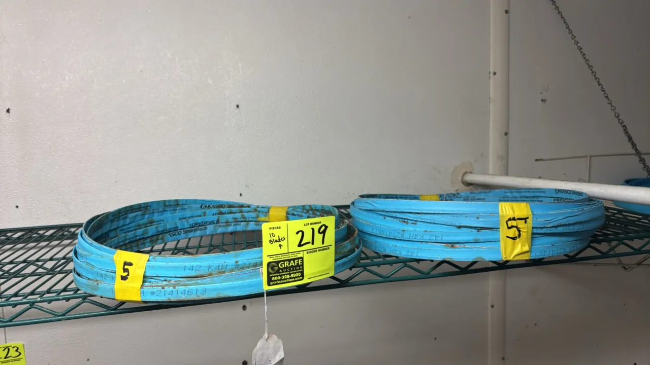 Kasco 142K4H meat saw blades. Band saw blades wrapped in blue protective tape. Note: Surface rust visible. Shelving not included.