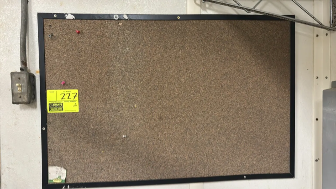Cork bulletin board. Features a cork tack surface with a black frame. 3' x 2'. Wall mounted.