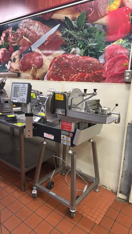 Bizerba A404 automatic slicer stacker. Features digital control panel with keypad display, stainless steel construction, product feed carriage, and sl