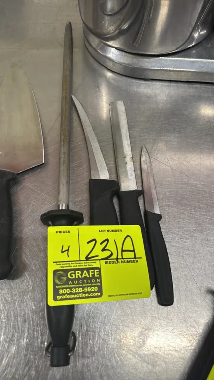 Various butcher knives and sharpening steel. Includes (3) assorted knives and (1) honing steel. Features stainless steel blades with black molded hand