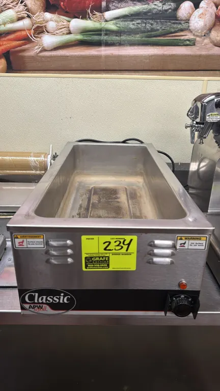 APW Wyott Classic countertop food warmer. Stainless steel construction with single full-size well. Features rotary temperature control dial and heatin
