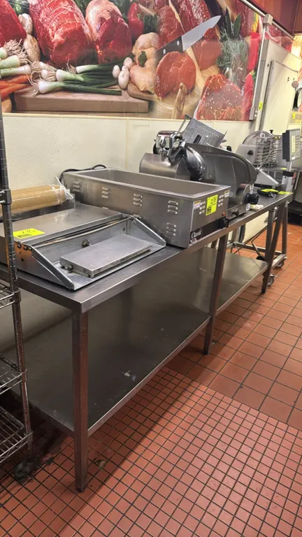 Stainless steel work table. Features a rear backsplash, full-length stainless steel undershelf, and square tubular legs. Dimensions: 96"L x 30"W. Note