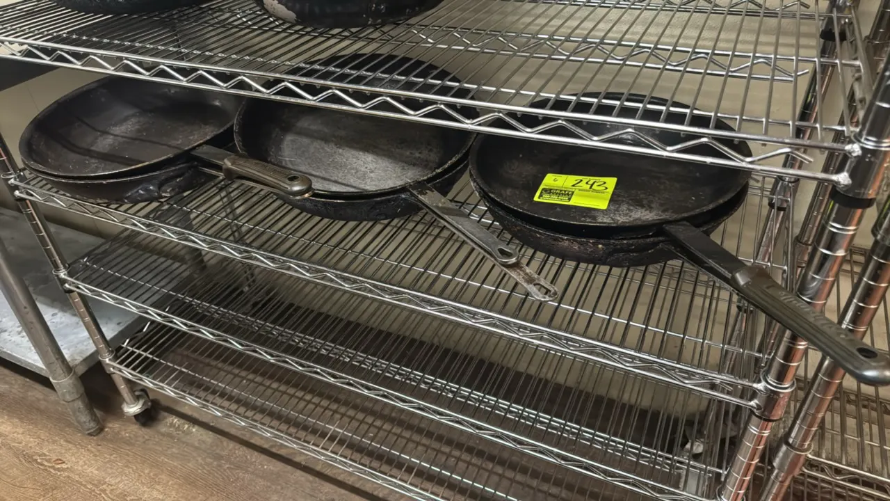 Aluminum frying pans. Features riveted handles and silicone handle sleeves. 14" dia. Wire shelving not included.