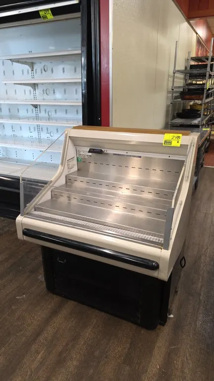 2013 Hussmann SHM-3 self-contained low-profile open refrigerated display case. Features 3-tier stainless steel display shelves, clear side and front p
