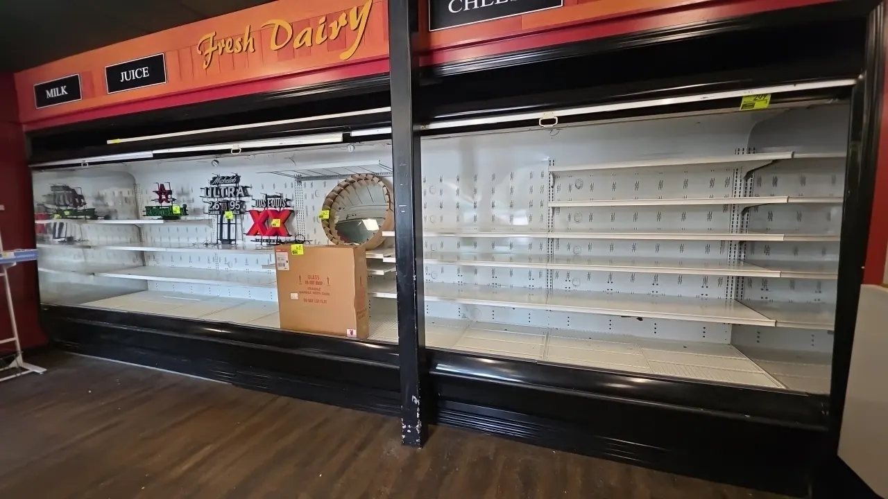 20'L Hill Phoenix upright multi-deck open dairy display case. Features multi-tier adjustable metal shelving, Miatech pull-down night shades, and canop