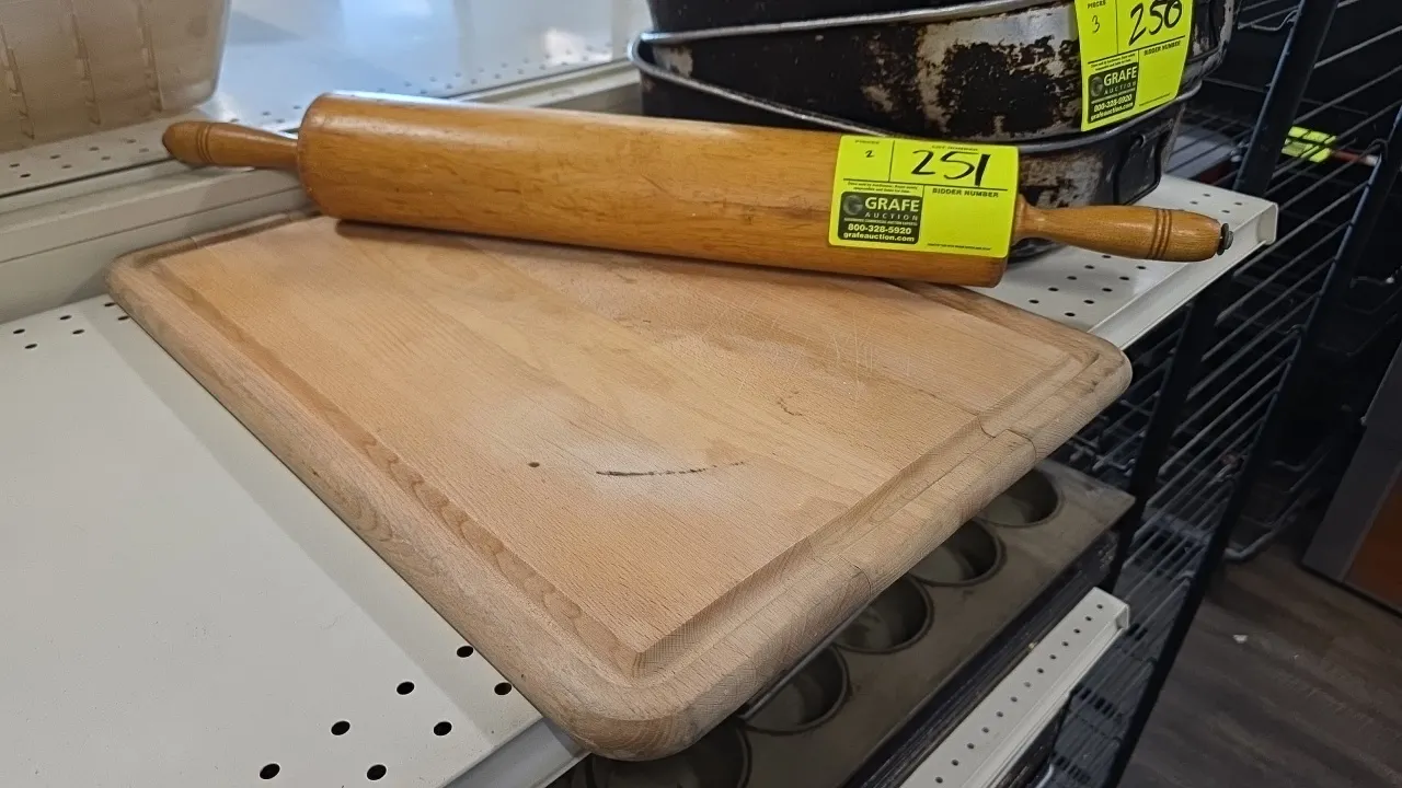 Thorpe 18" wood rolling pin with 21" x 15" wood cutting board. Rolling pin features revolving wooden handles. Cutting board features perimeter juice g