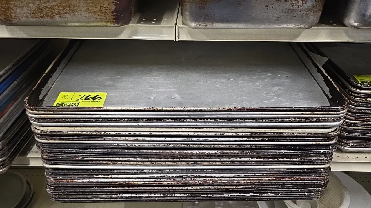 Full-size sheet pans. Includes aluminum sheet pans and (1) polymer sheet pan. Features wire-reinforced rolled edges. Shelving and background items not