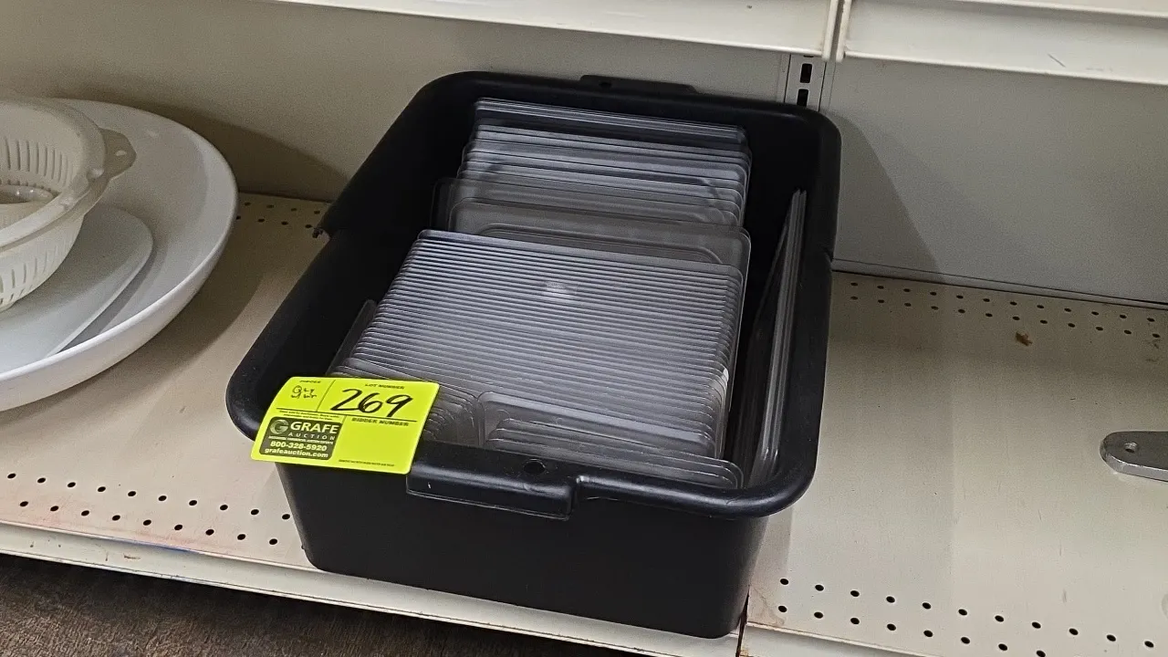 Cambro assorted clear polycarbonate food pan lids with black plastic bin. Includes various sizes of fractional food pan lids.