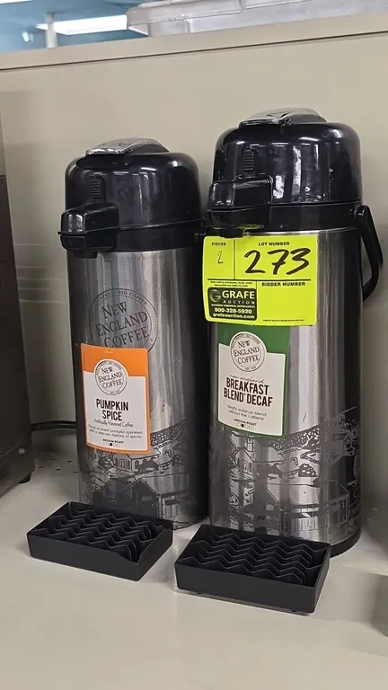 Stainless steel thermal coffee dispensers. Features lever-action pump lids, integrated carry handles, and New England Coffee graphics. Includes (2) bl