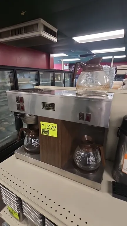Bunn Pour-Omatic VPS commercial coffee maker. Features stainless steel construction with woodgrain accent panel, brew funnel, (3) warming stations, an