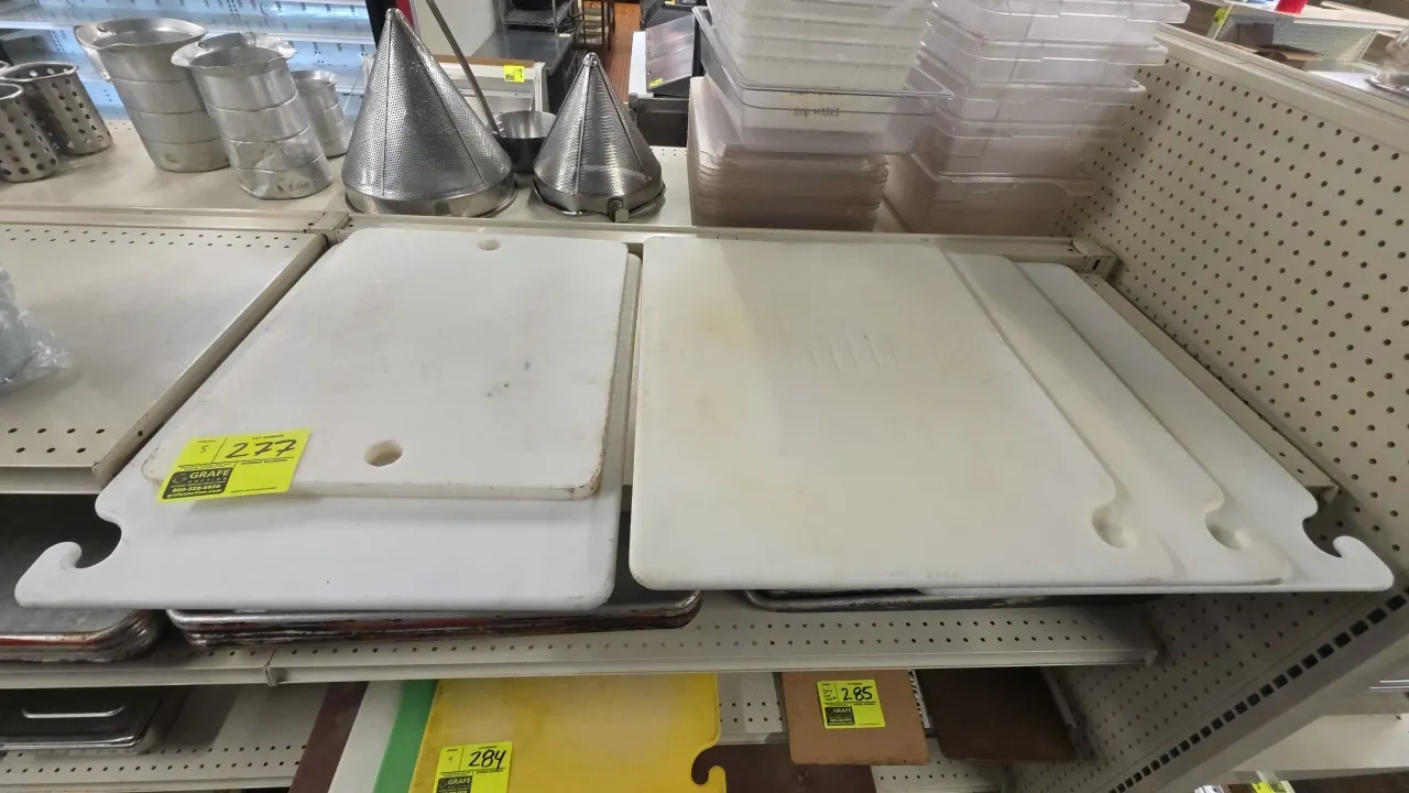 Polyethylene cutting boards. Features white poly construction, integrated corner hanging hooks, and cutout handles. Dimensions: (1) 16" x 20" and (4)