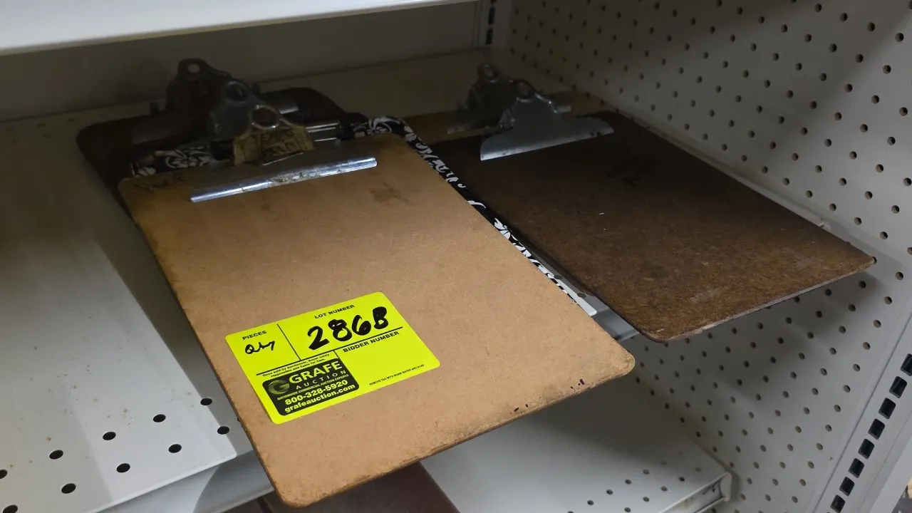 Assorted clipboards. Features hardboard construction with top metal spring-action clips. Shelving not included.