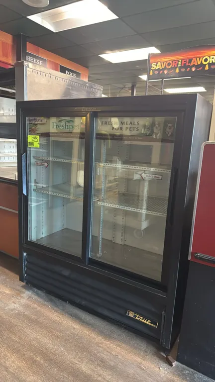 True GDM-41SL-54 self-contained sliding glass door display cooler. Features (2) double-pane sliding glass doors, adjustable wire shelving, black exter
