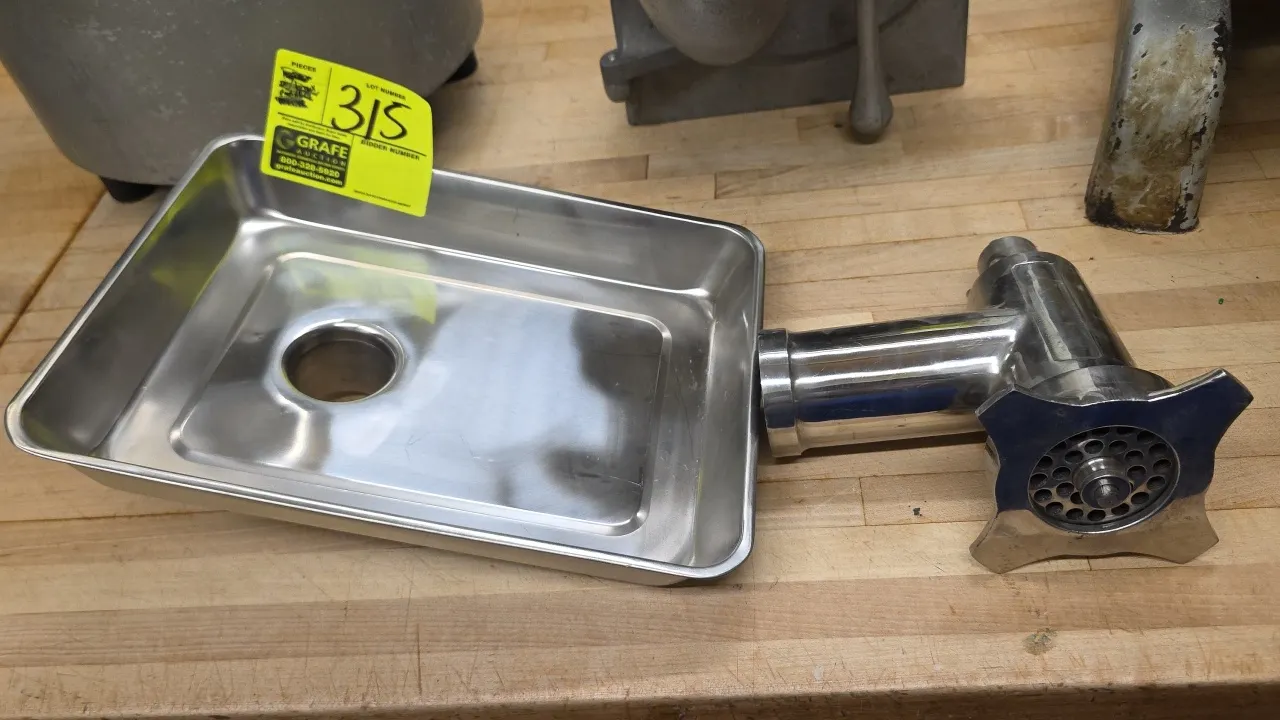 Hobart stainless steel meat grinder attachment with tray. Features feed pan, grinder housing with worm, grinding plate, adjusting ring, and square dri