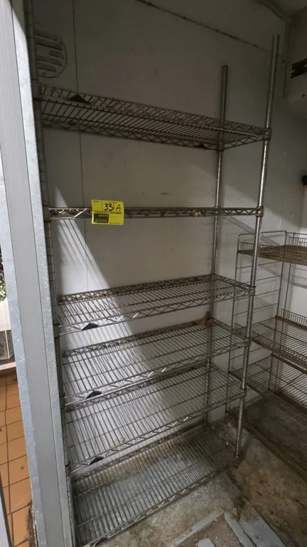 6-tier metal wire shelving rack. Features six adjustable wire shelves and four vertical posts. Dimensions: 36"W x 12"D x 80"H. Note: Adjacent shelving