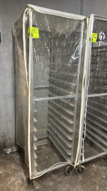 Aluminum speed rack. Includes clear zippered plastic cover. Features 20-tier sheet pan slides. Mounted on swivel casters.