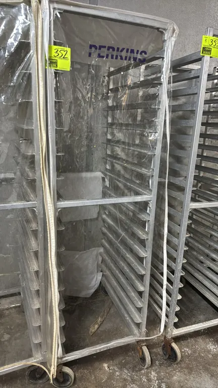 Aluminum speed rack. Features end-load sheet pan slides and a clear vinyl zippered cover. Mounted on swivel casters.