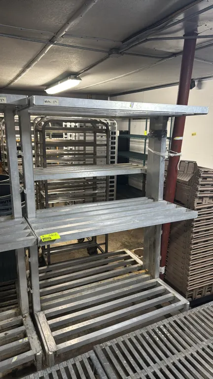 Aluminum 3-tier racks. Features welded aluminum construction and 3-tier slotted shelving. Dimensions: 48"L x 20"W x 72"H. Surrounding equipment not in