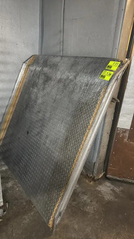 Magliner aluminum dock plate. Features diamond tread plate surface, raised side curbs, and underside locking legs. 5,000 lb capacity. 5' x 5'.