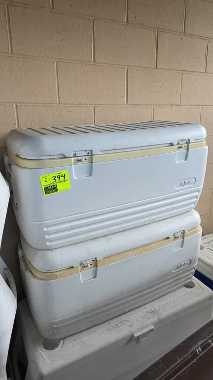Igloo insulated coolers. Features hinged lids, dual front latches, and swing-up side handles. 3'L. Note: One unit has cracked plastic on the side and